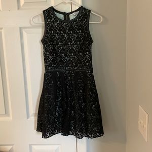 Simple but elegant, black dress with a light greenish lining. Size 1  .